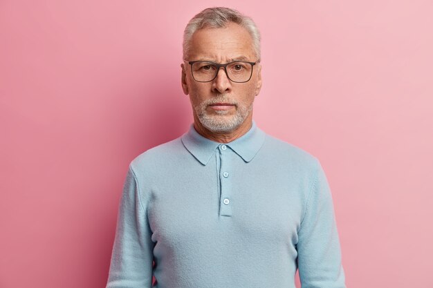 Senior man wearing blue shirt and glasses