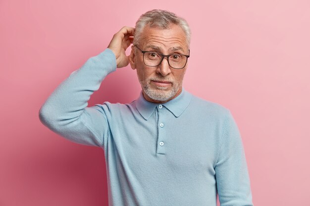 Senior man wearing blue shirt and trendy eyeglasses