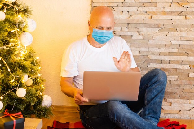 Senior man wearing surgical face mask at home.