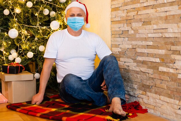 Senior man wearing surgical face mask at home.