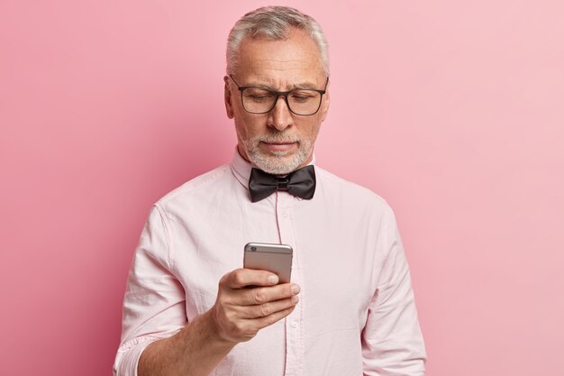 Senior man wearing white shirt and black bowtie