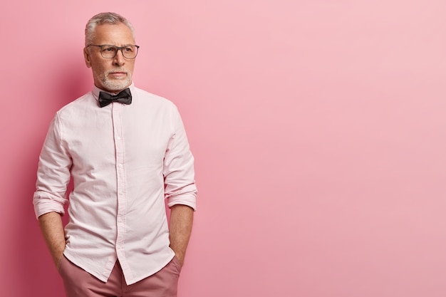 Senior man wearing white shirt and black bowtie