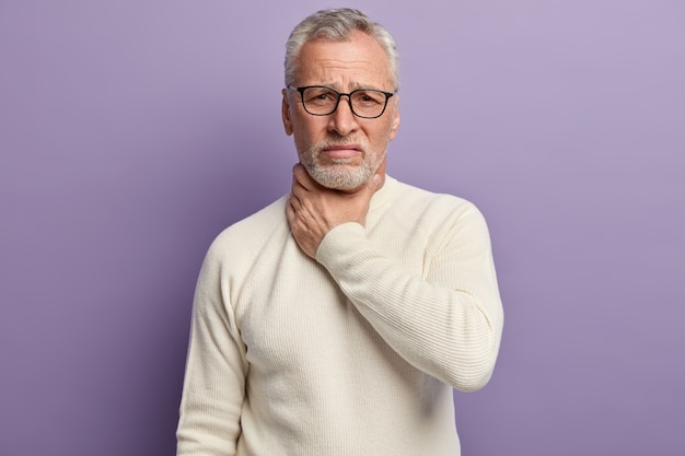 Senior man wearing white sweater and trendy eyeglasses