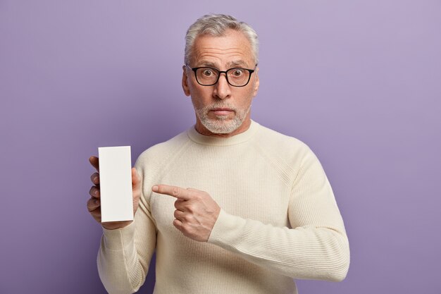 Senior man wearing white sweater and trendy eyeglasses