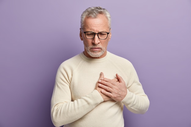 Senior man wearing white sweater and trendy eyeglasses