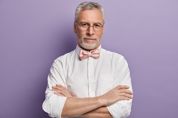 Senior man in white shirt and pink bowtie