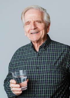 Senior man with a glass of water