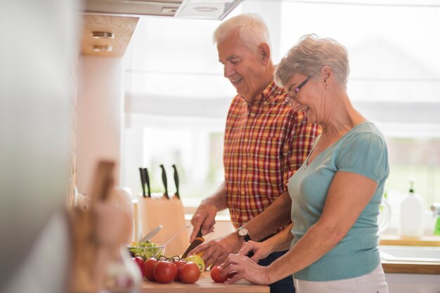 Senior marriage preparing a meal together