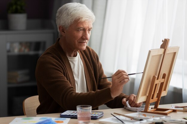 Senior painter using watercolor for his art