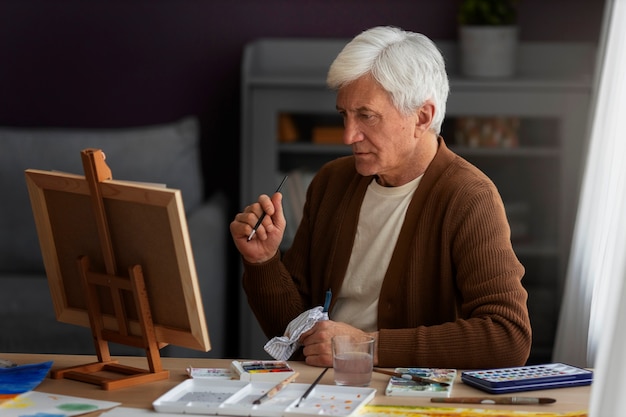 Senior painter using watercolor for his art