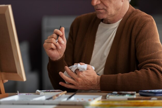 Senior painter using watercolor for his art