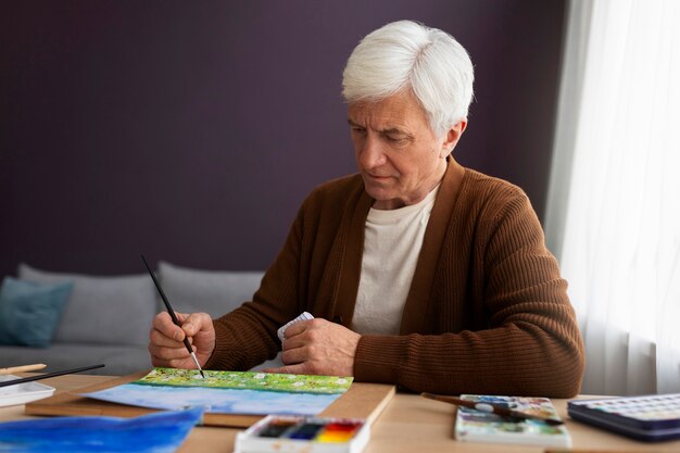 Senior painter using watercolor for his art