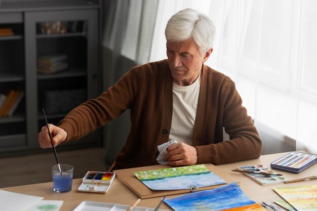 Senior painter using watercolor for his art