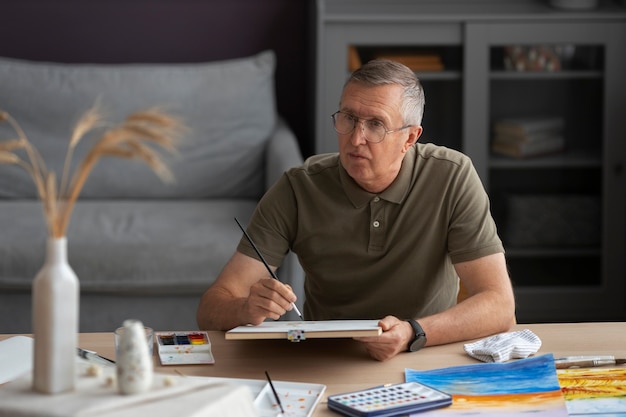 Senior painter using watercolor for his art