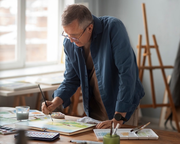 Senior painter using watercolor for his art