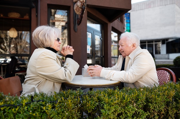 Senior people holding hands medium shot