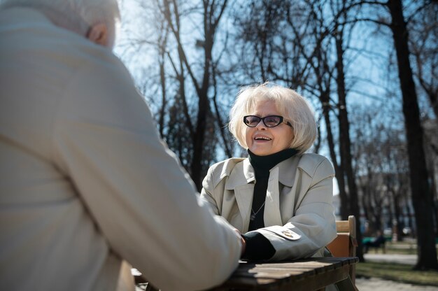 Senior people holding hands side view