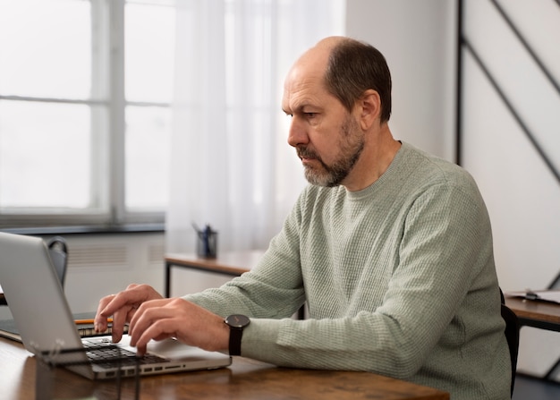 Senior people in school during class with laptop computer