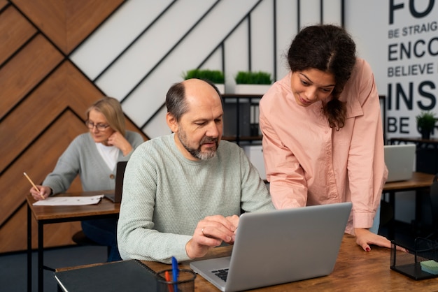 Senior people in school during class with laptop computer