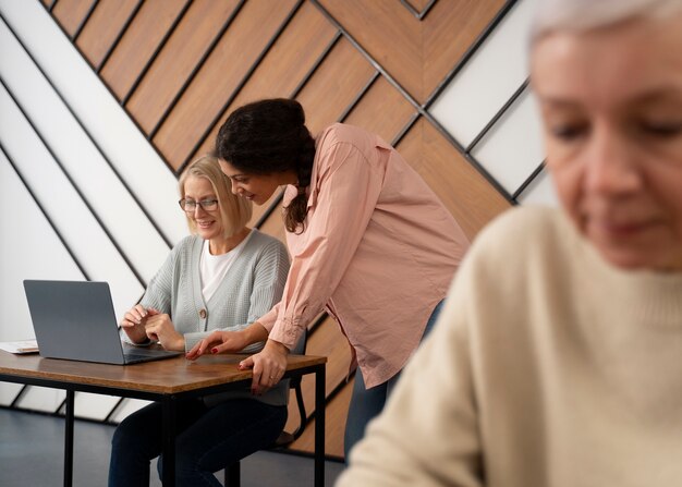 Senior people in school during class with laptop computer