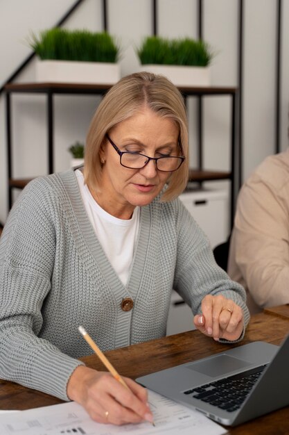 Senior people in school during class with laptop computer