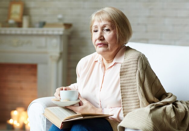 Senior reader in living room