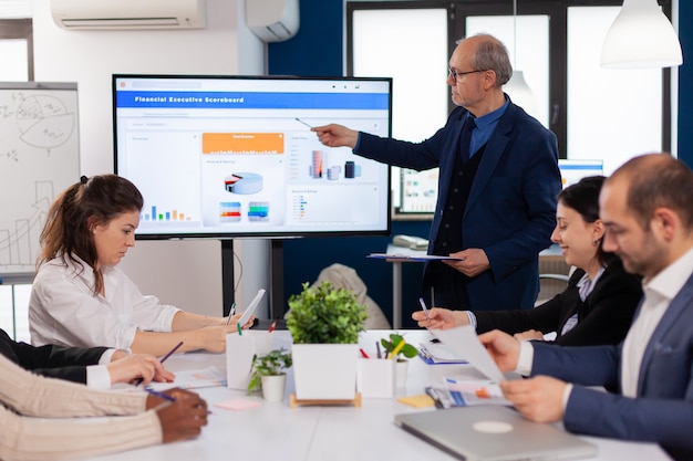 Free photo senior team leader explaining presentation discussion in conference room briefing planning