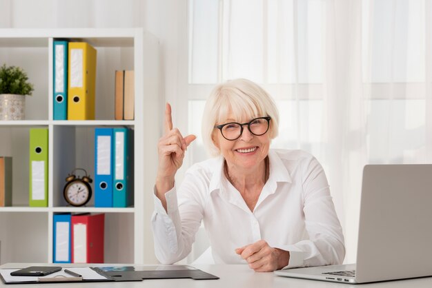 Senior with eyeglasses sitting in her office