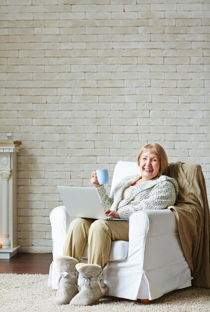 Senior woman addicted to Internet