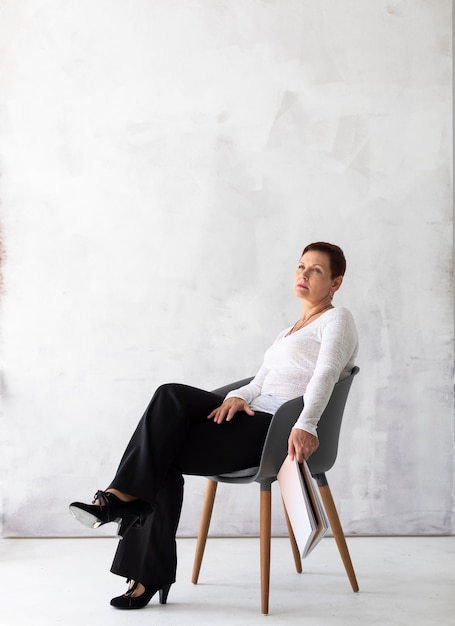 Senior woman on a chair thinking