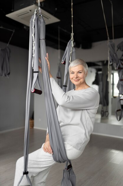 Senior woman doing a warm-up at the gym