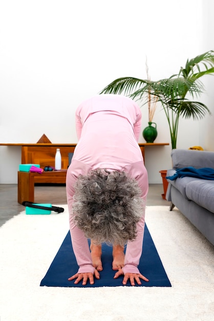 Free photo senior woman exercising indoors front view