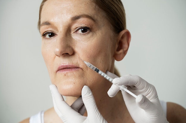 Senior woman getting facial injection