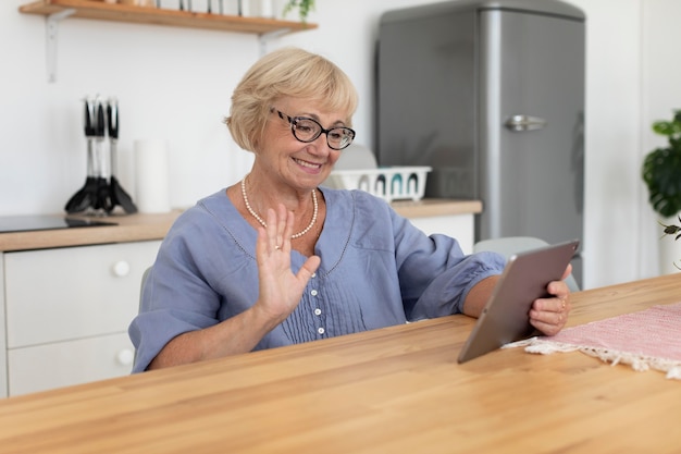 Senior woman having a videocall with her family