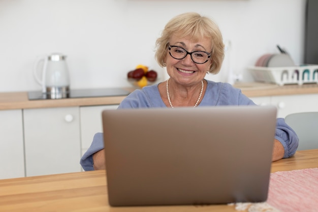 Senior woman having a videocall with her family