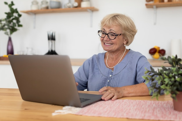 Senior woman having a videocall with her family