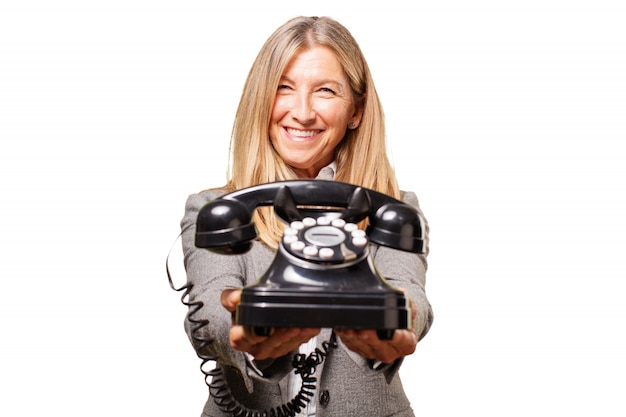 Senior woman holding an old phone