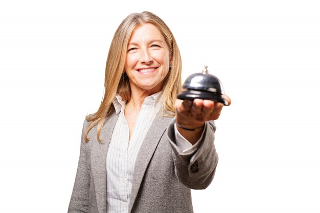 Senior woman holding a reception bell