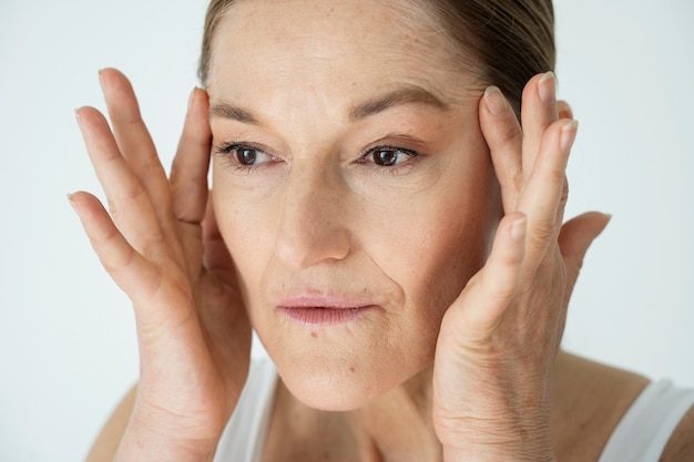 Senior woman lifting face close up