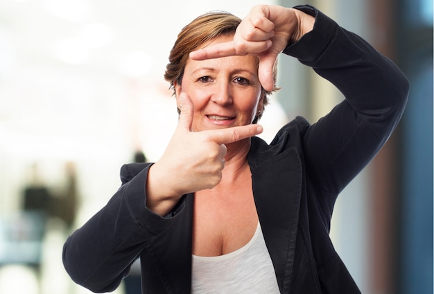 Senior woman making the gesture frame