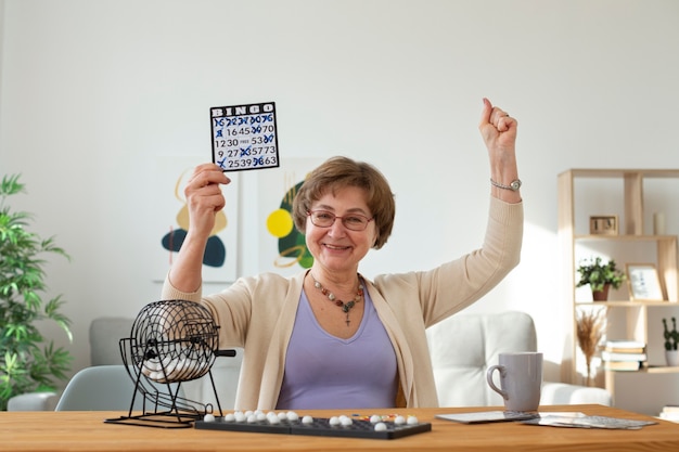 Senior woman playing bingo medium shot
