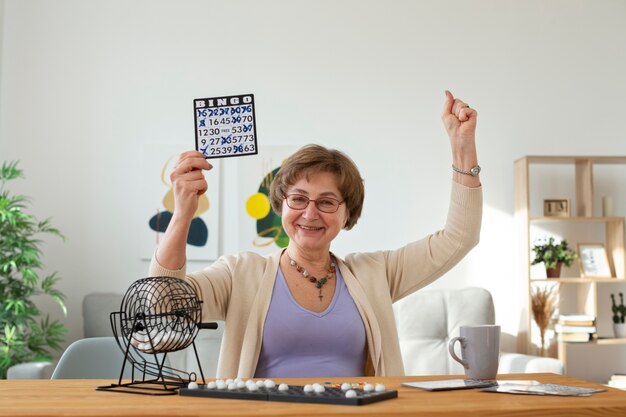 Senior woman playing bingo medium shot