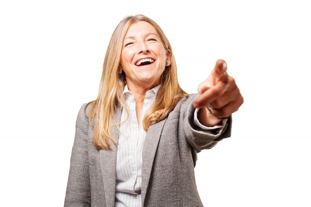 Free photo senior woman pointing and laughing