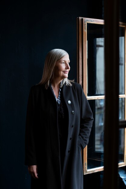 Senior woman posing indoors front view