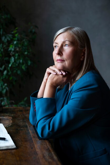 Senior woman posing inside medium shot