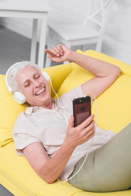 Senior woman relaxing listening music on headphone