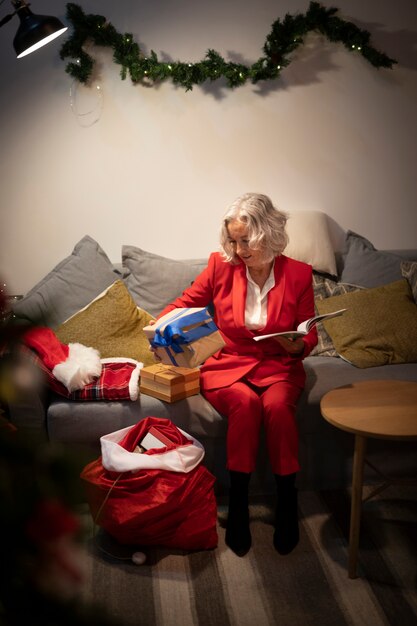 Senior woman setting up christmas gifts