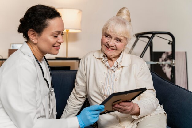 Senior woman showing her doctor a photo in a frame