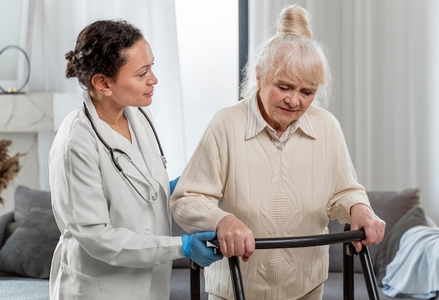 Senior woman standing indoors next to doctor