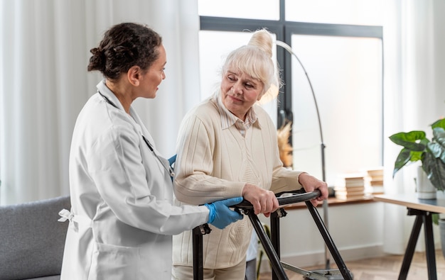 Senior woman standing indoors next to doctor